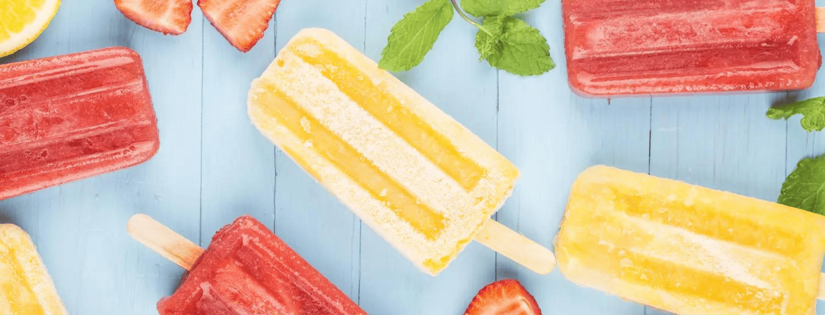 popsicles and fruit on a blue background